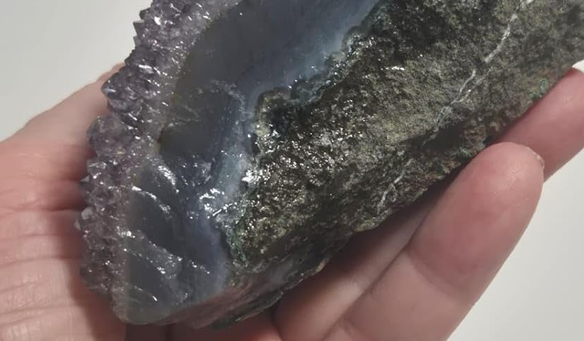Drusa Natural de Ametista com cristais violeta e formação mineral exclusiva fotografada na mão